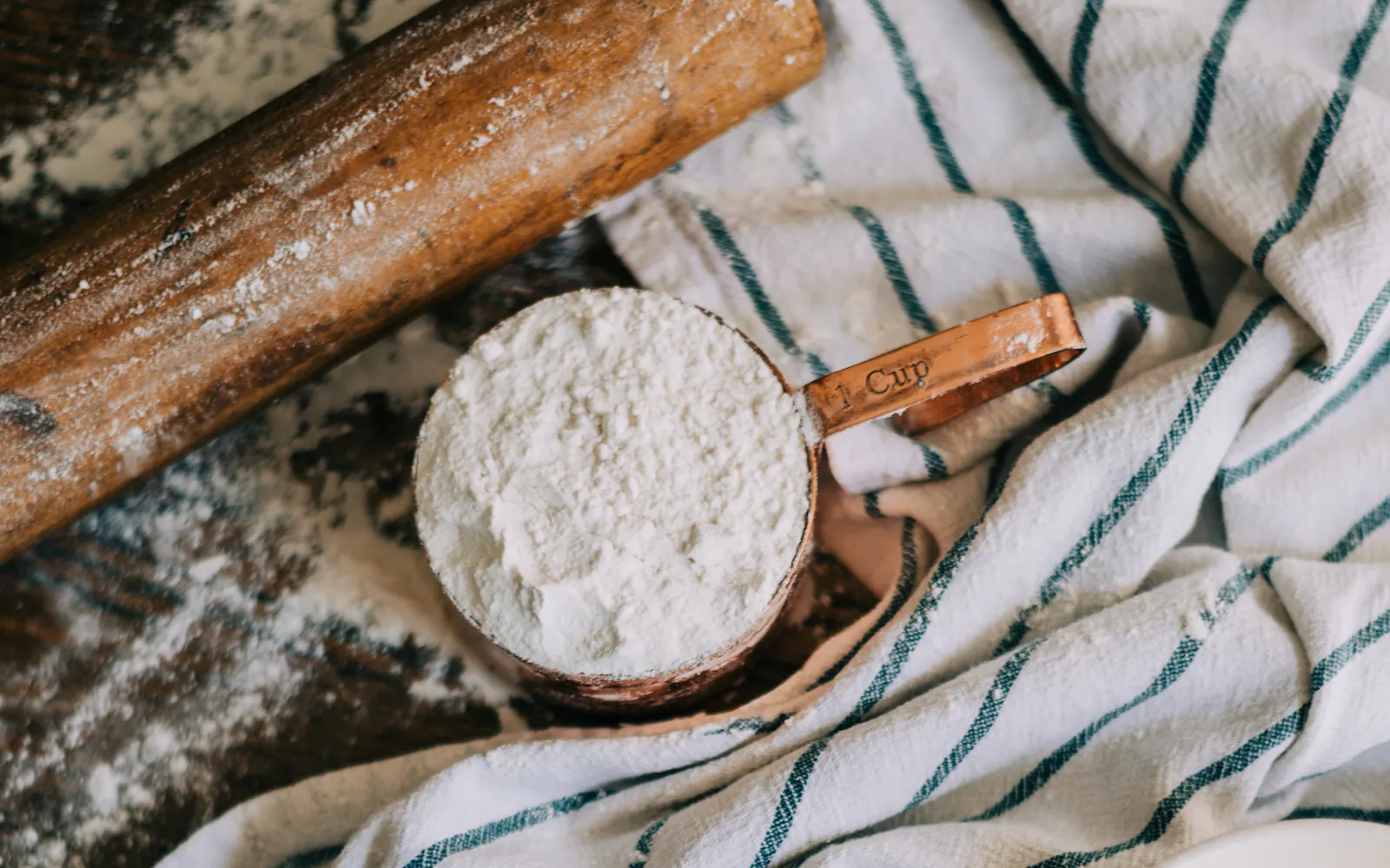 Measuring cup of flour with eggs and butter