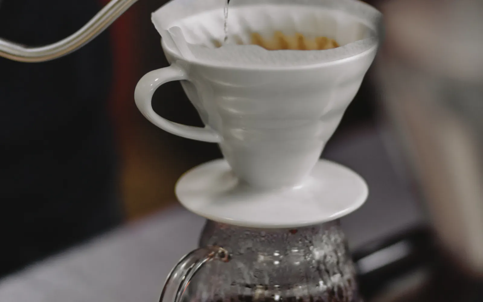 Hot water being poured over coffee in a pour-over brewer